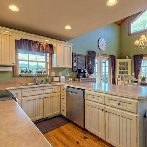 Cute country kitchen with lots of countertop space and light from all angles!