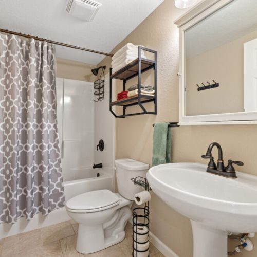 Basement level shared bathroom.