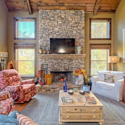 Large comfy seating and stone fireplace in living room