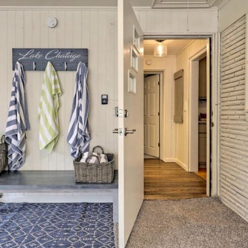 Garage with beach towels, laundry area, gas grill and a cornhole game