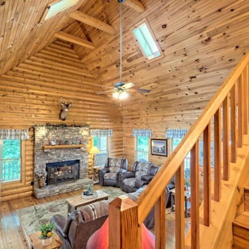 A nice rock fireplace with a hearth and comfy seating and open spaces