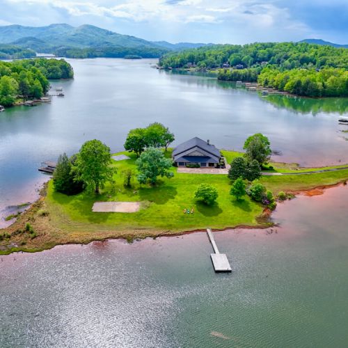 Arial view of home on its own peninsula of the lake.