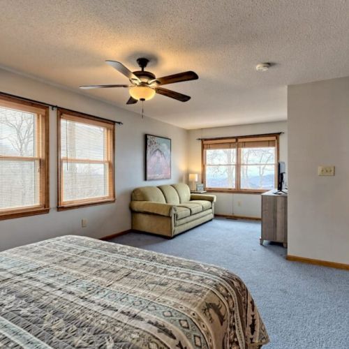 Full view of loft bedroom w/ ensuite and a nice comfy sofa and TV to curl up with. Bring your hot chocolate!