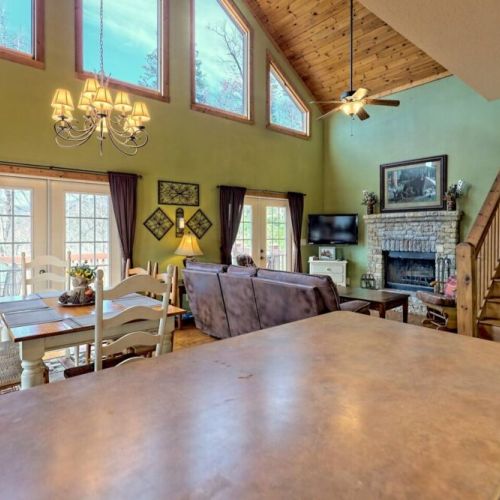 Living / dining open concept with the upstairs in view. Don;t miss that fireplace!