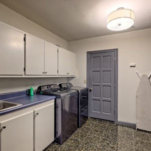 Laundry room off kitchen hallway