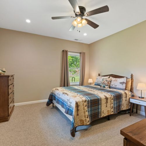 Basement level bedroom with queen bed.