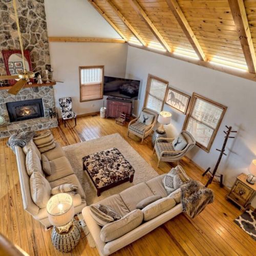 From top of stairwell into the comfortable seating and the inviting fireplace