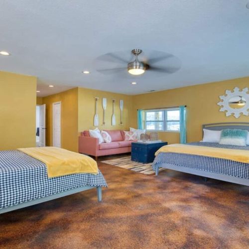 Lower level large spacious bedroom with 2 large beds and some comfy sofa seating.
