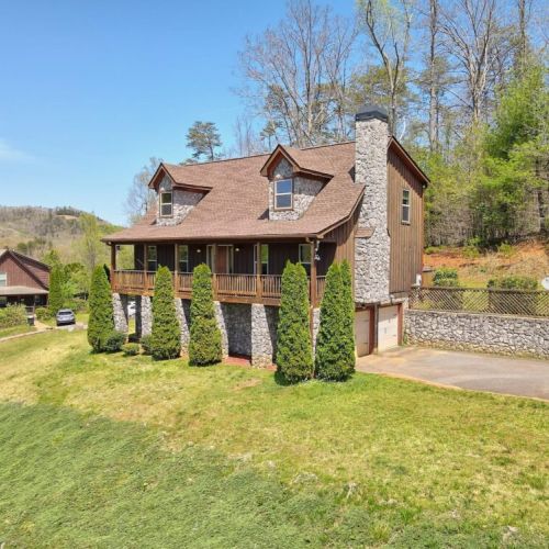 View of the big yard space and wonderful front porch across the whole front of the house!