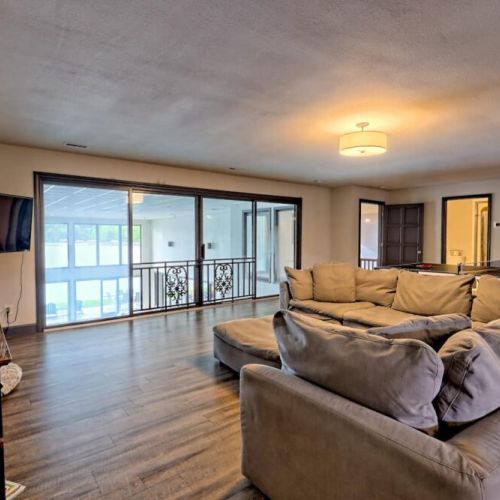 Upstairs lounging / game / TV area overlooking the pool and lake.