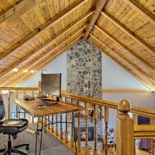 Loft area desk  with monitor and showing off those beautiful vaulted ceilings!