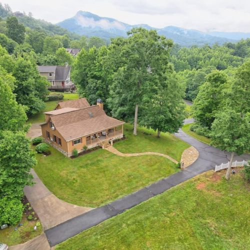 Aerial view of the property and surrounding large yard for family fun!