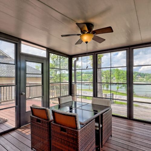 All weather sunroom with a nice view of the lake and seating for 4.