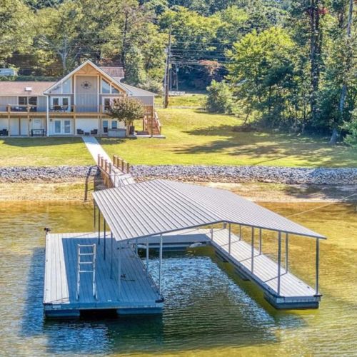 Walkway and view of the private dock looking back at the wonderful outdoor spaces off the rear of the home.