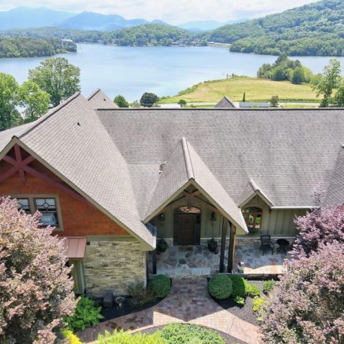 Front view of property and lake just beyond