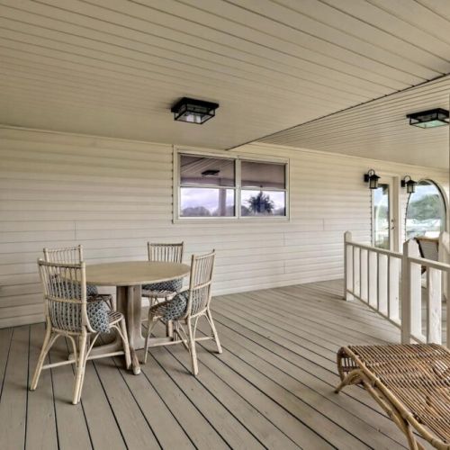 A covered porch with more seating and dining