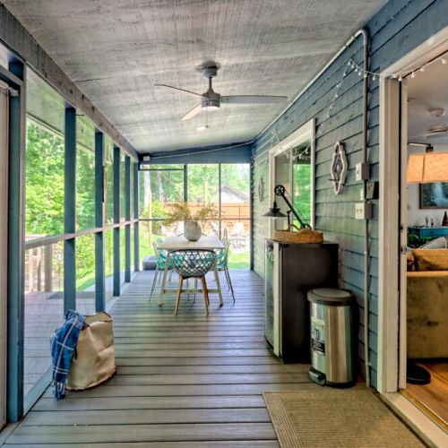 Outdoor seating on screened in back patio.