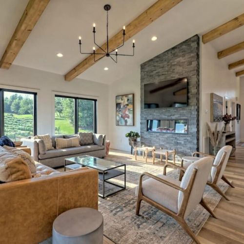 Open arrangement of living area with plenty of seating with fireplace