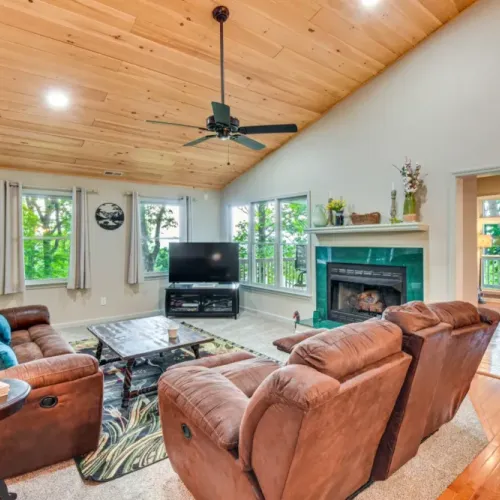 Upper level living room with tv and gas fireplace