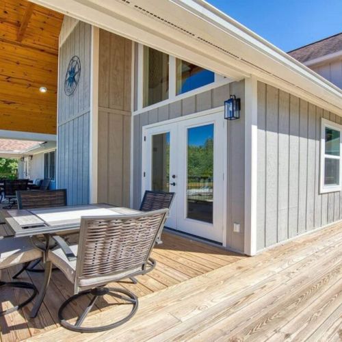 Deck & sitting area off the living room and double sets of french doors. Dining options on both ends of the deck.
