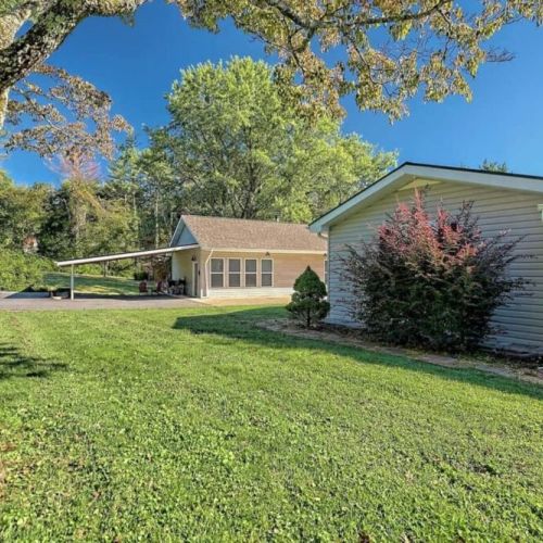 HOUSE in forefront. Farther away pic with carport overhang is the cottage.