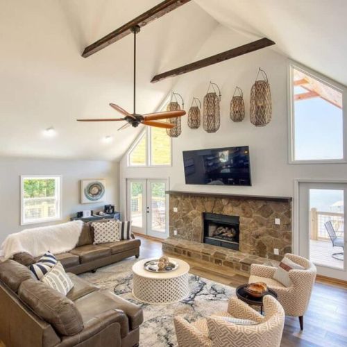 Lots of comfy, cushy sofa and loveseat lounging options in front of the mammoth fireplace.