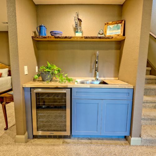 Basement wet bar with a drink cooler.