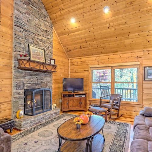Nice stacked stone floor to ceiling fireplace with screen cover and plenty of seating!