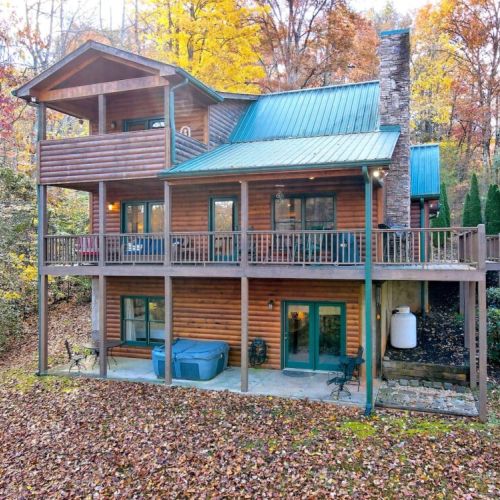 View of the back of house showing all decks and the hot tub :)