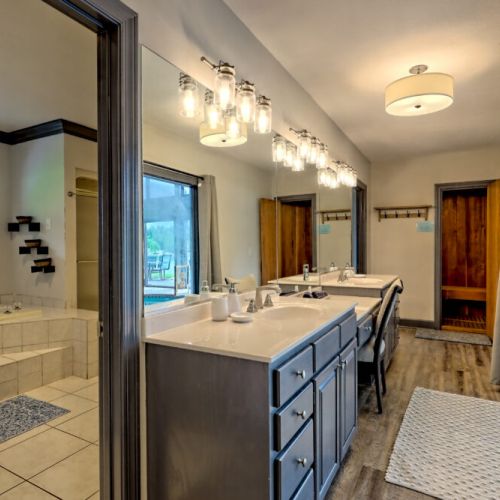 Master bathroom vanity area and view of the sauna entrance