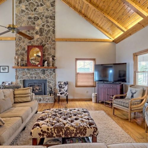 Lots of comfortable seating in the living room and a magnificent floor to ceiling  fireplace!