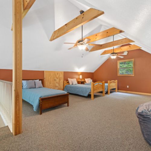 Upstairs loft with one full bed and two twin beds.