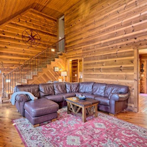 View of spacious living room to upstairs and into dining area