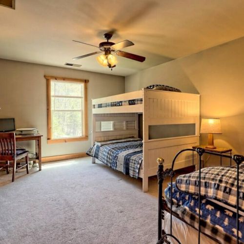Upstairs bedroom with beds for 3 and a desk area